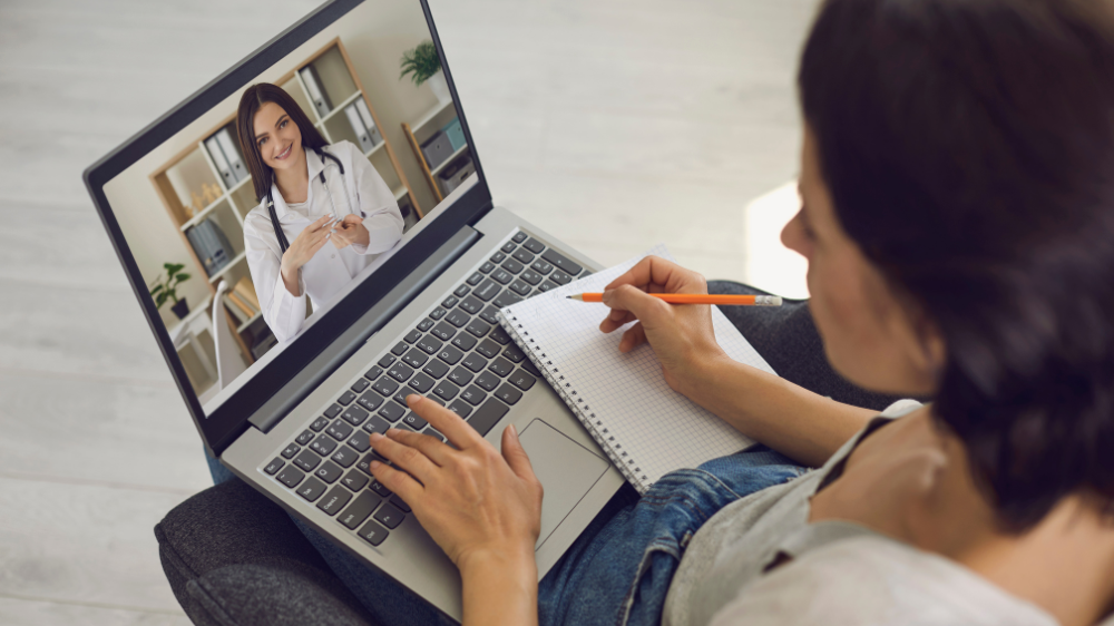 Online medical consultation. The patients consults with the doctor using the video conference application of the medical clinic remotely. Virtual clinic concept.