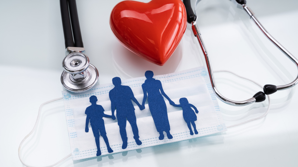 silhouette of a family on top of a facemask, stethoscope, and heart item